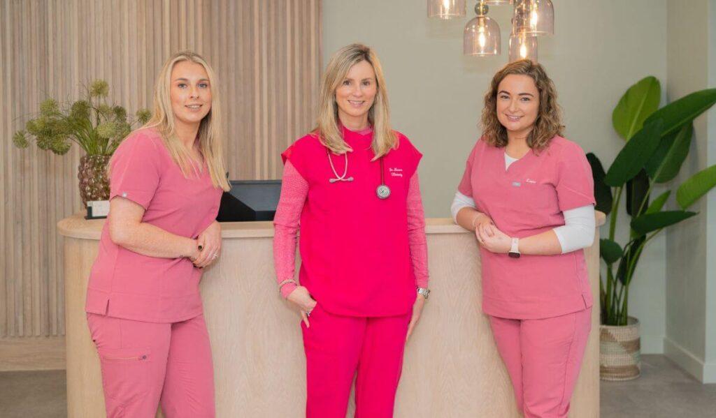 Dr Maeve and Team standing wearing pink